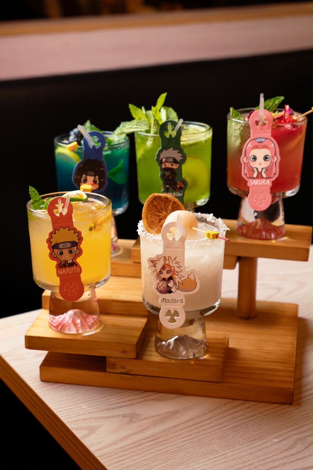 Anime cocktails served on tiered wooden stands